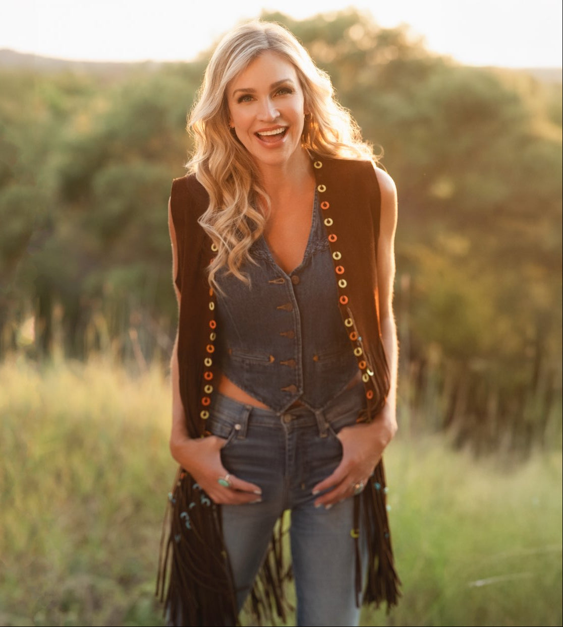Woman wearing a vest with decorative buttons in a field
